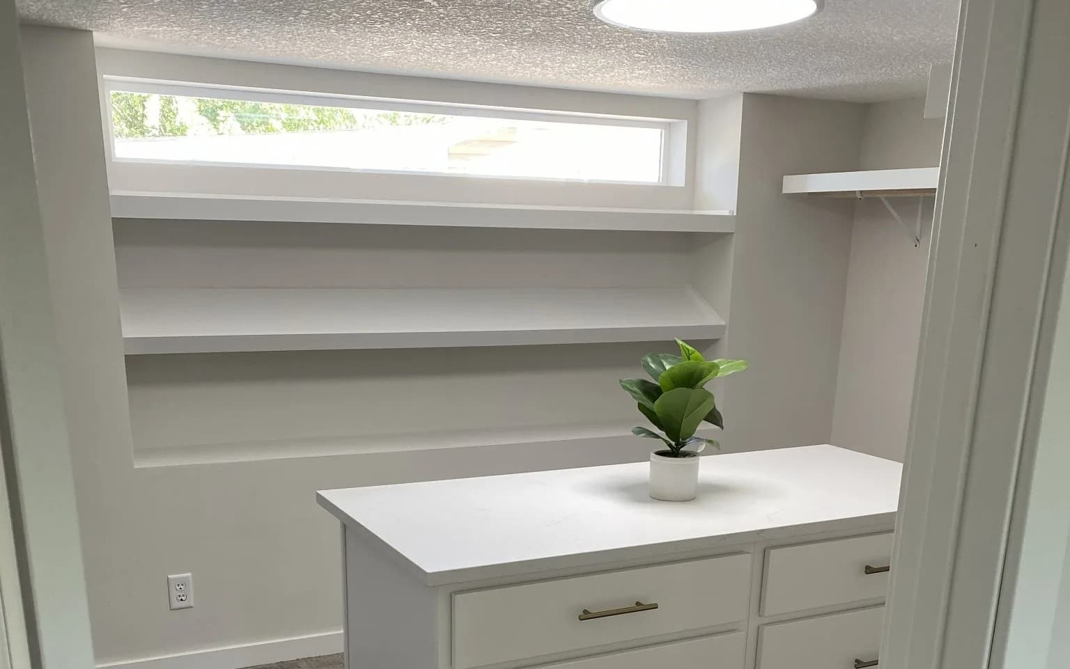 Walk-in closet with custom island carpentry in a Forest Lake, MN home